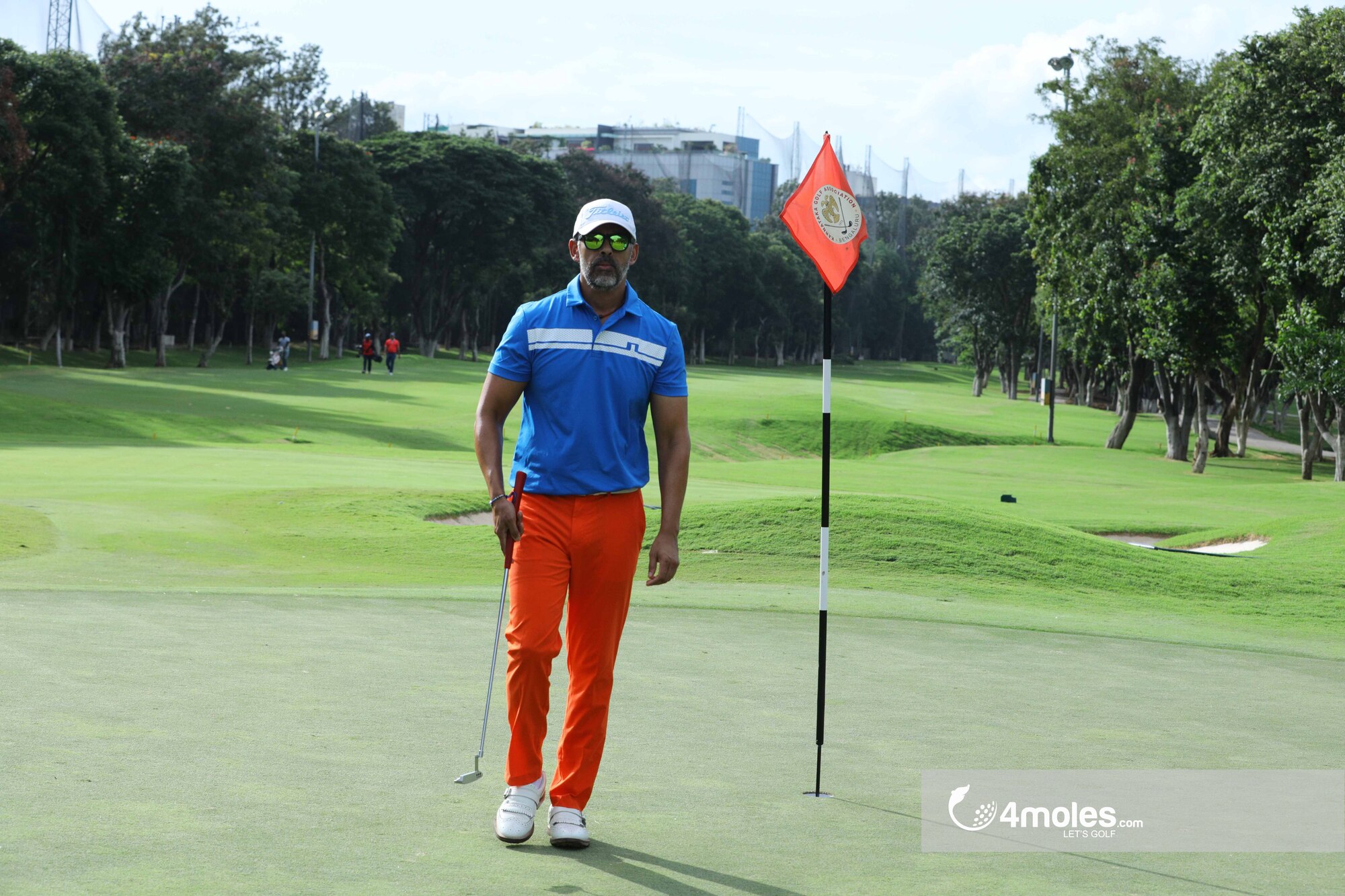 Golfer at the pin after finishing.